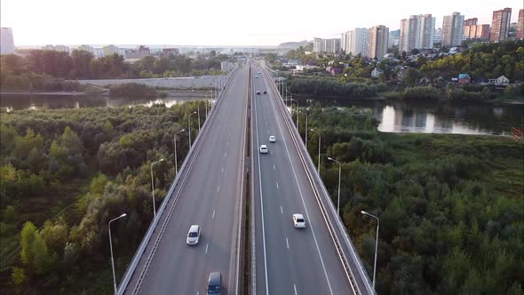 View of Cars Driving on the Road Highway Bridge Aerial Highaltitude Flight of a Drone alt