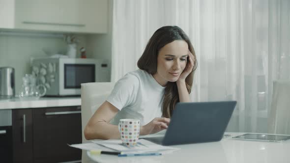 Tired Woman Working Laptop Computer at Home Workplace. Frustrated Person alt