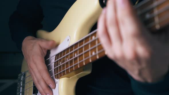Person Beats Metal Bass Strings Before Using Slap Technique alt
