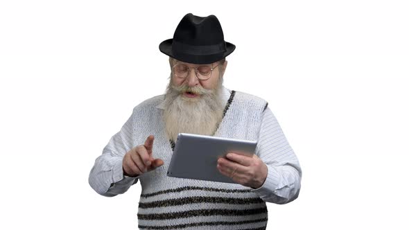Aged Man in Eyeglasses Using Digital Tablet alt