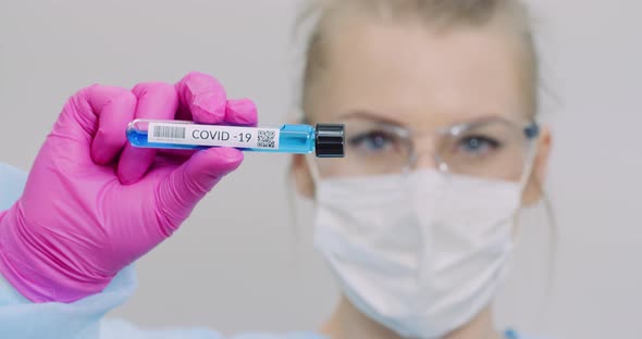 Researcher Holding Covid-19 Sample Tube in Hand alt