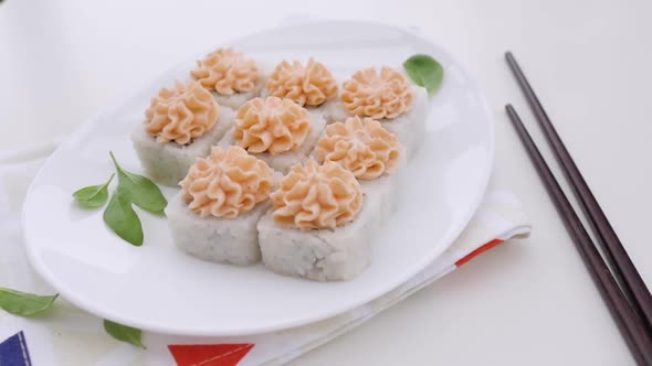 Various Types of Sushi Are Beautifully Served in a Rustic Style alt