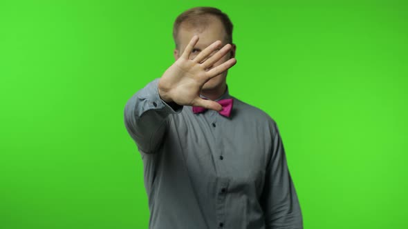 Man Raising Hand Warning of Danger, Showing Stop Gesture, Protecting From Danger. Telling To Stop alt