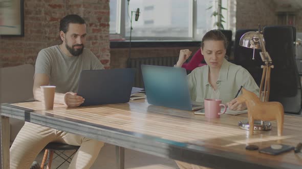 Friends are Working Together on a Common Project Smiling and Laughing alt