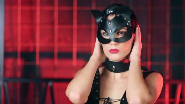 Closeup Face Seductive Domination Female in Black Latex Sexual Clothing Looking at Camera alt