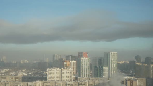 City Pipes Emit Steam Into the Arctic Atmosphere Against the City Skyline