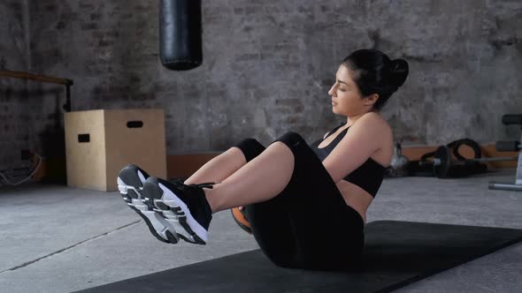 Young Indian Athletic Woman Doing a belly Press Exercise Uses a Ball, Dressed in Sportswear alt