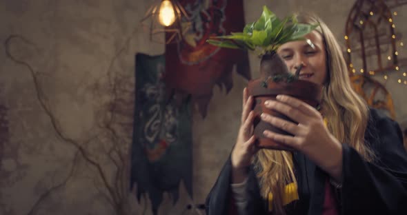 Student of the Wizard School is Holding a Flower Pot with Mandragora Root alt