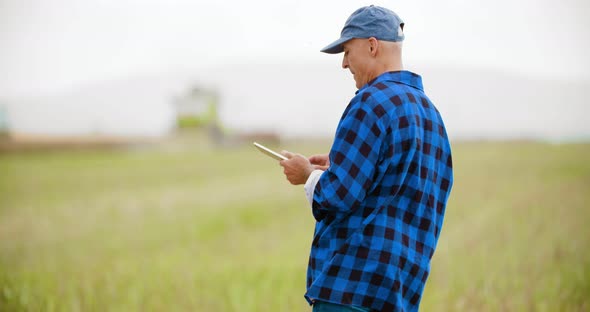 Farmer Working Field using Digital Tablet alt