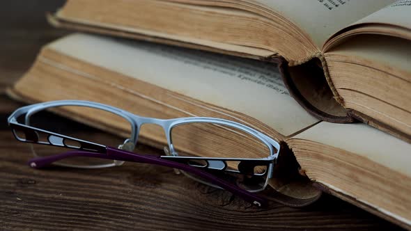 Books and glasses on wooden table