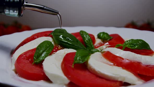 Pouring Olive Oil Over Caprese Salad 32