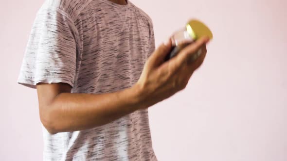 Young Man making coffee with coffee powder. Man opening coffee powder jar alt