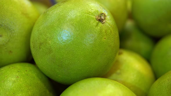 Woman's Hand Taking Pomelo Fruit From Shelves