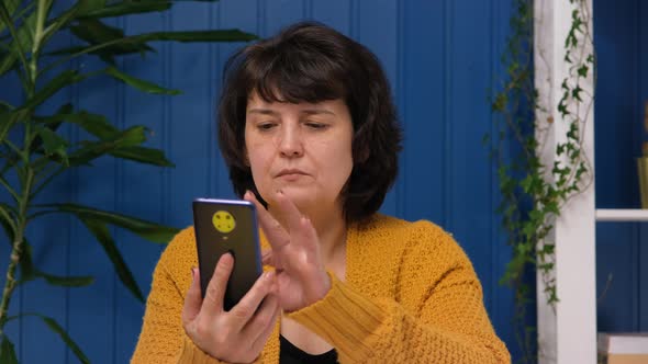 Middle Aged Woman Using Phone at Home