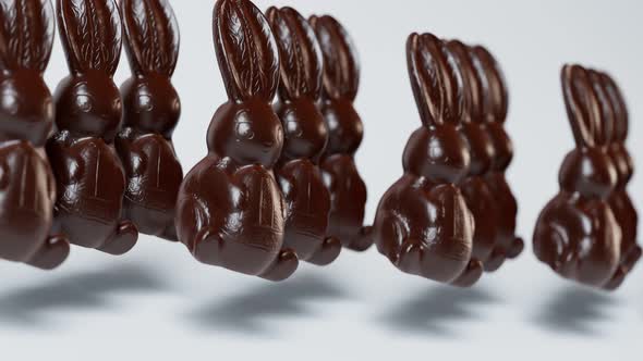 Loopable animation of cute chocolate jumping Easter bunnies.  Happy Easter. alt