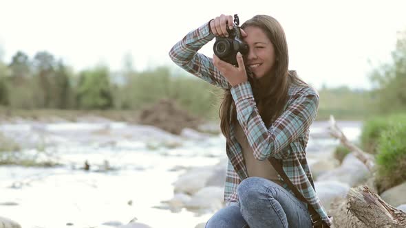 Young girl taking pictures outdoors