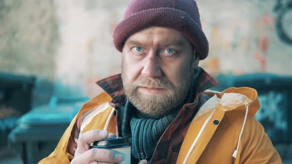 Close Up of a Homeless Man Holding a Coffee Cup alt
