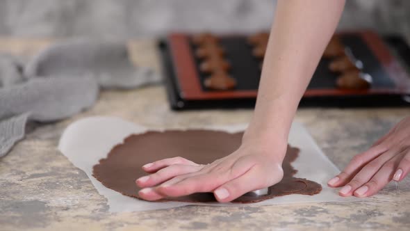 Woman Cutting Chocolate Shortcrust Dough Into Circles. Making Choux Buns with Craquelin alt