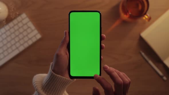 Top View of Female Hands Tapping on Green Screen of Mobile alt