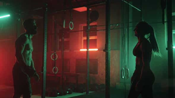 Sporty Handsome Man and Beautiful Woman in Gym After Training Smiling and Clapping Hands alt