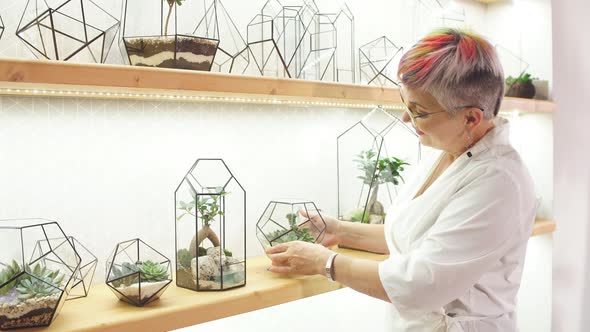 Careful Female Florist Take Care of Plants alt