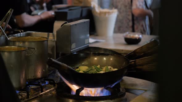 Chinesse Chief Cook Cooking on the Wok Pan with Flambe on the Asian Restaurant Kitchen Pasta Seafood alt