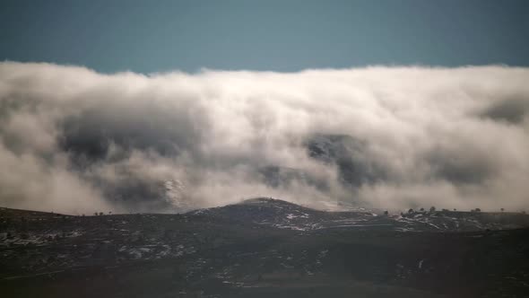 8K Mist Cloud Flowing Down Ridge of Mountain Range