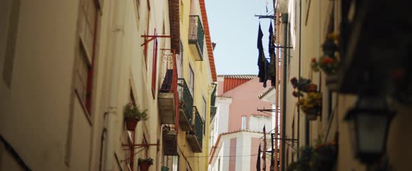 Scenic view of a narrow street in Lisbon alt