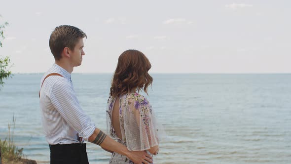 The Guy Comes Up to the Girl Hugs and Strokes Her Hair the Girl Smiles at Him Slow Motion alt