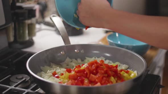 Pouring Red Sauce on Vegetables