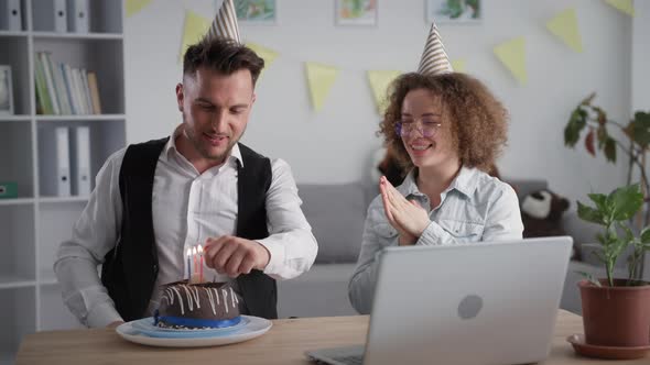 Celebrating Onlinehappy Boyfriend and Girlfriend in Holiday Caps Blowing Out Candles on Cake During alt