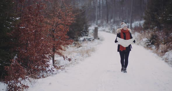 Tourust Walking with Map in Woods alt