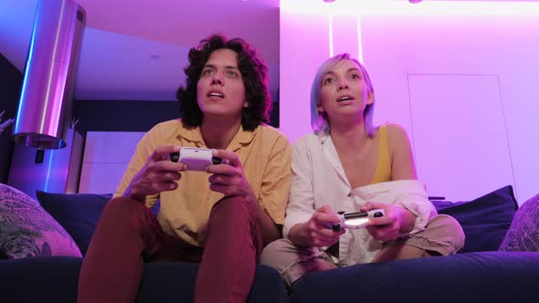 Young Girl Playing Video Games with Her Boyfriend and Sad About Losing To Him alt