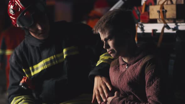 Rescuers Supporting Teen Survivor at Night alt