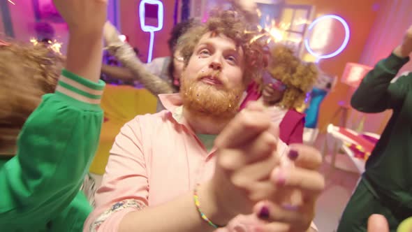 POV of Tipsy Man Dancing with Sparkler at College Party alt