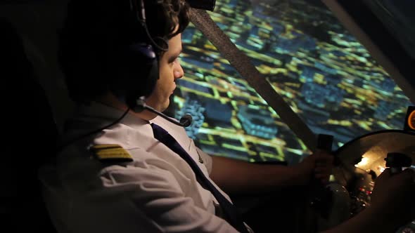 Commercial Pilot in Beautiful Uniform Controlling Airplane Above Night City alt