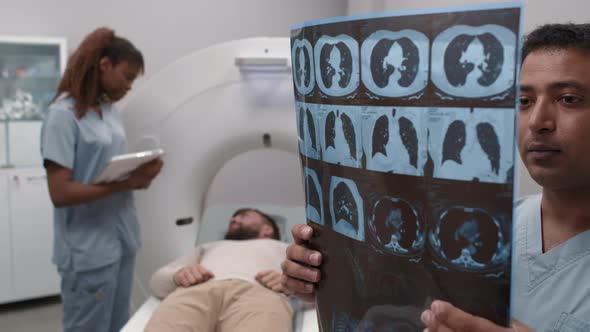 Radiologist Reading X-Ray of Lungs in CT Scan Room alt