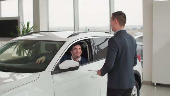 Car Purchase Automobile Dealership Professional Manager Giving New Vehicle Keys to Happy Vehicle