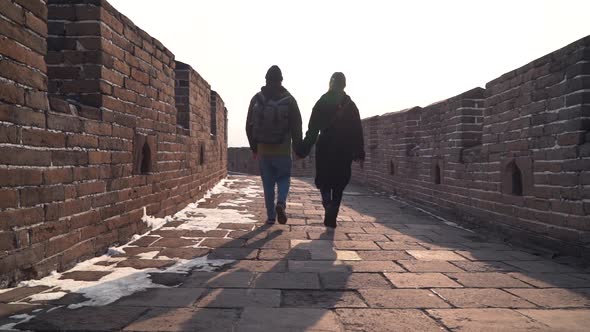 Couple Explore Great Wall of China Together, Low Camera on Stone Pavement of Wide Passage. Tourists