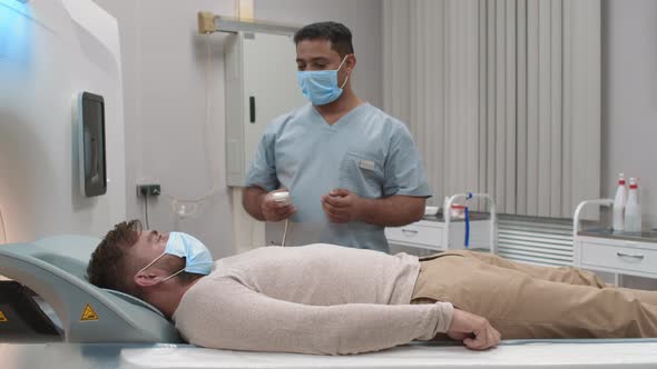 Tech Performing CT Scan of Patient alt