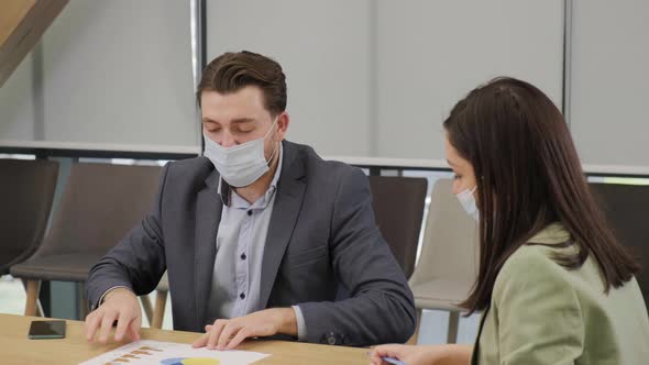Business People Having a Meeting Working in the Office Wearing Medical Mask alt