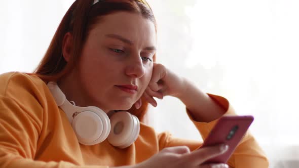 Beautiful Caucasian Young Woman Using Smartphone Relaxing Listening to Music