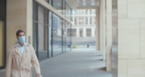 Businessman Leave Office Building and Remove Safety Mask Outside alt