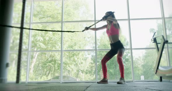 Beautiful Young Woman Does Training with Weighted Bar in Gym. Attractive Female Training alt