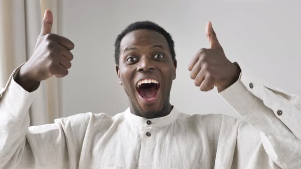 Excited AfricanAmerican Guy Shows Thumbs Up and OK Gestures alt