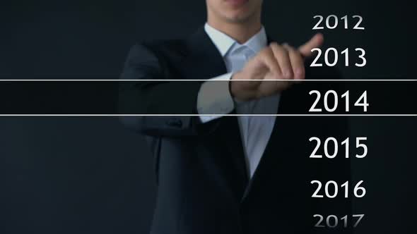 Businessman Selects 2019 Year in Virtual Menu, Search for Data, Business History alt