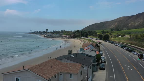 low aerial view of million dollar beachfront homes in Mondo Beach along the pacific coast highway ro alt