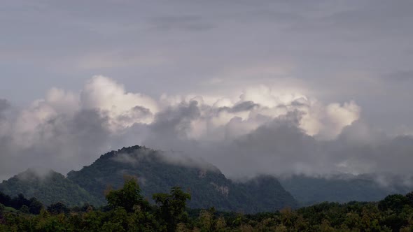 Dramatic Cumulus tropical cinematic cloudscape building up over the mountain turning into a tropical alt