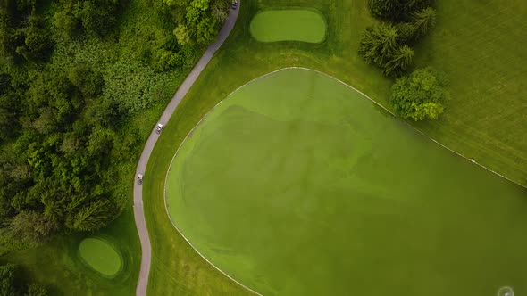 Overhead drone shot of a beautiful golf course. alt