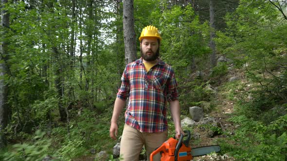 a Chainsaw Worker Goes Through the Woods